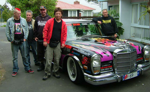 All the band together lounging on the limo